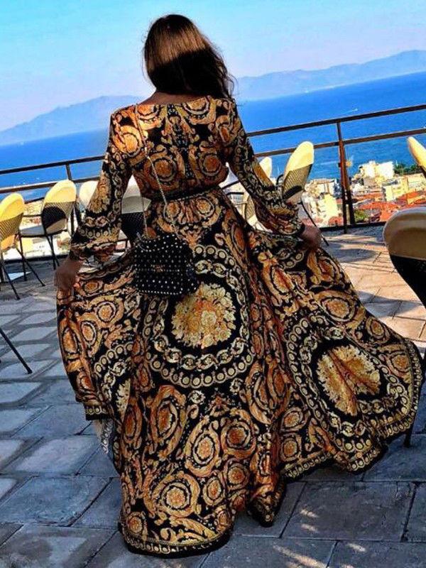 Robe longue parure noire et dorée cache-coeur
