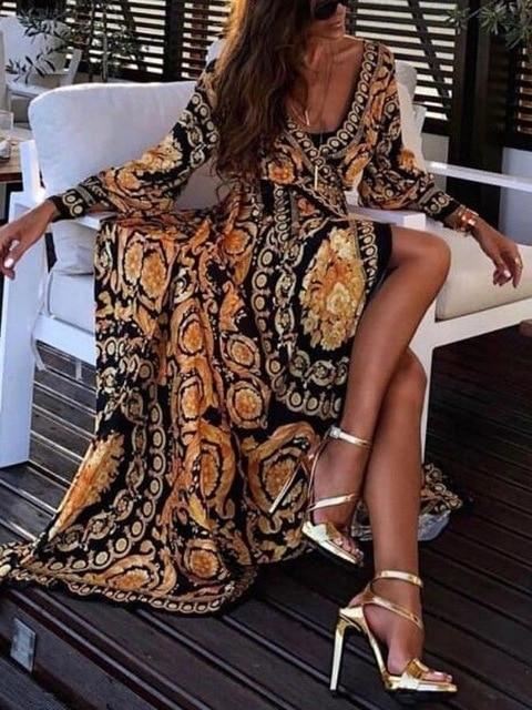 Robe longue noir et dorée cache-coeur parure